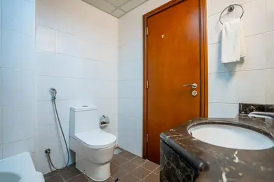 a bathroom with a toilet and a sink at RH- Chic & Sleek Studio apartment, near Burj Khalifa in Dubai