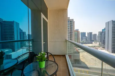 a balcony with a table and a view of a city at RH- Chic & Sleek Studio apartment, near Burj Khalifa in Dubai