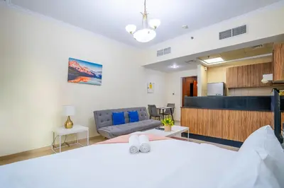 a living room with a bed and a couch at RH- Contemporary Studio, Downtown, Near Dubai Mall & Burj Khalifa in Dubai