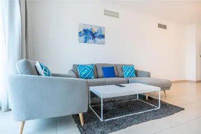 a living room with a couch and a coffee table at RH- Modern Elegance 2BR, prime location, Walk to Dubai Mall in Dubai