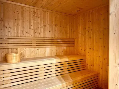 a wooden sauna with a wooden bench in it at The Smart Concierge - Waves By KASCO in Dubai