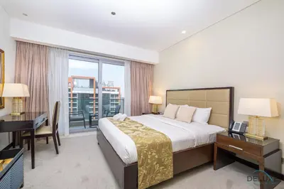 a bedroom with a bed and a desk and a window at Marina Canal Views from the Balcony, Close to Marina Mall, The Address Residences, Dubai Marina by Deluxe Holiday Homes in Dubai