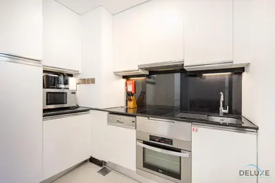 a kitchen with white cabinets and stainless steel appliances at Marina Canal Views from the Balcony, Close to Marina Mall, The Address Residences, Dubai Marina by Deluxe Holiday Homes in Dubai