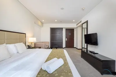 a bedroom with a large white bed and a flat screen tv at Marina Canal Views from the Balcony, Close to Marina Mall, The Address Residences, Dubai Marina by Deluxe Holiday Homes in Dubai