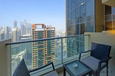 a balcony with a table and chairs on a building at Marina Canal Views from the Balcony, Close to Marina Mall, The Address Residences, Dubai Marina by Deluxe Holiday Homes in Dubai