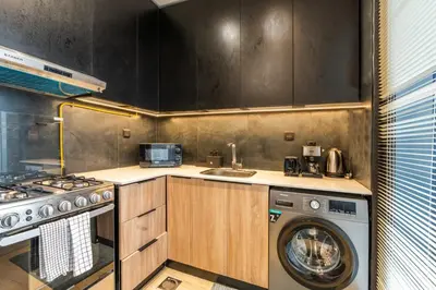 a kitchen with a washing machine and a washer at GuestReady - Zen in the heart of JVC in Dubai
