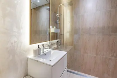 a bathroom with a white sink and a mirror at GuestReady - Zen in the heart of JVC in Dubai