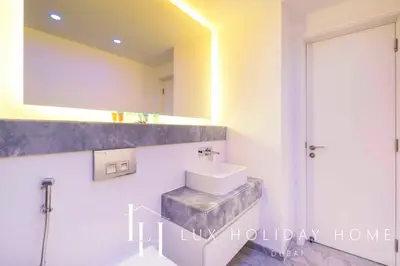 a bathroom with a sink and a mirror at LUX The Pad Executive Suite Canal View 4 in Dubai