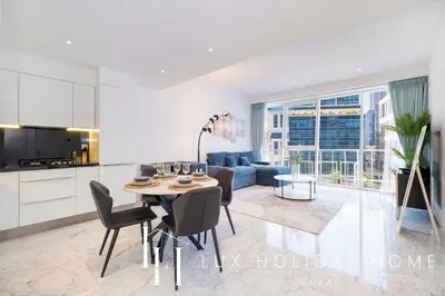 a kitchen and living room with a table and a couch at LUX The Pad Executive Suite Canal View 4 in Dubai