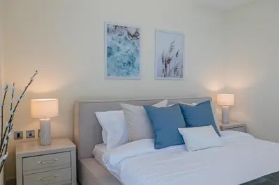 a bedroom with a bed with blue and white pillows at 2BDR apartment with full sea view and Dubai Marina view Azure Residences in Dubai