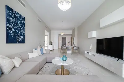 a living room with a couch and a tv at 2BDR apartment with full sea view and Dubai Marina view Azure Residences in Dubai