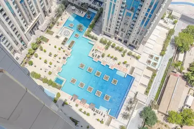 an overhead view of a swimming pool in a city at Hashtag Holiday Home - 1BDR Apartment with Canal View in Business Bay in Dubai