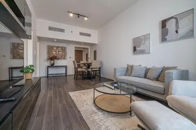 a living room with a couch and a table at Hashtag Holiday Home - Excellent 1BDR with City View in Media city in Dubai