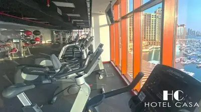 a gym with a row of exercise bikes in it at Palm Jumeirah Upgraded & Cozy Boutique Apartment in Dubai