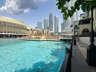 a large swimming pool in the middle of a city at Trophy - Downtown Scape Views Suite in Dubai