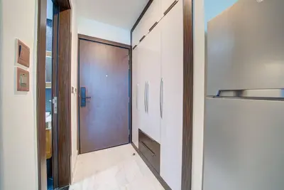 a hallway with a sliding door in a room at Lovely studio in Business Bay in Dubai