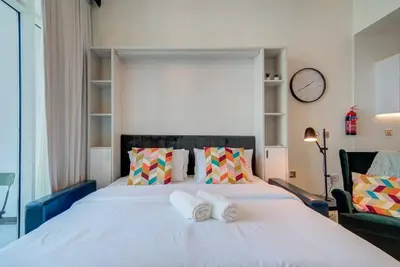 a bedroom with a bed with two towels on it at Lovely studio in Business Bay in Dubai