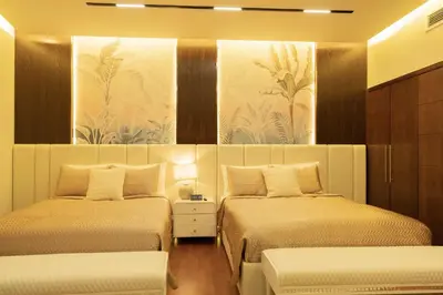 a bedroom with two beds and a painting on the wall at Luxury 3 BR - Direct View to Burj Khalifa in Dubai