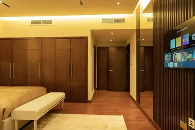 a bedroom with a bed and a flat screen tv at Luxury 3 BR - Direct View to Burj Khalifa in Dubai
