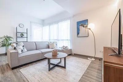 a living room with a couch and a table at 1BDR Apartment in Dubai Marina with Marina Views in Dubai