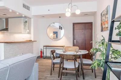 a kitchen and dining room with a table and chairs at 1BDR Apartment in Dubai Marina with Marina Views in Dubai