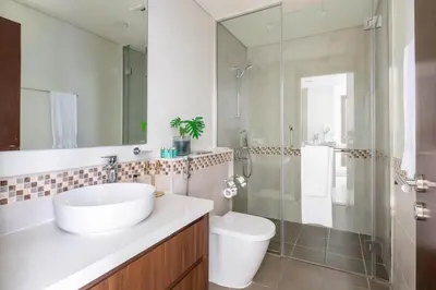 a bathroom with a sink and a shower and a toilet at Frank Porter - Vera Residence in Dubai