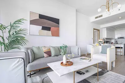 a living room with a couch and a table at Frank Porter - Bloom Tower A in Dubai