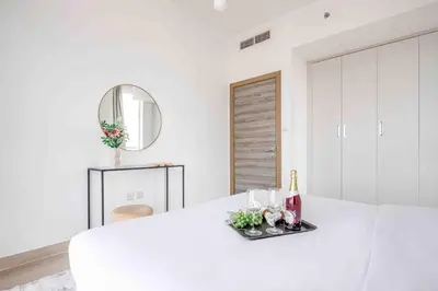 a white room with a white table and a mirror at Frank Porter - Bloom Tower A in Dubai