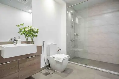 a bathroom with a toilet and a sink and a shower at Frank Porter - Bloom Tower A in Dubai