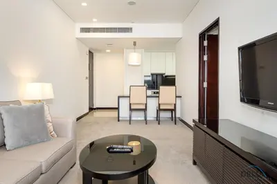 a living room with a couch and a table at Marina Canal Views 1BR Minutes Away from Marina Mall, The Address Residences, Dubai Marina by Deluxe Holiday Homes in Dubai