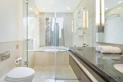 a bathroom with a toilet and a sink and a shower at Marina Canal Views 1BR Minutes Away from Marina Mall, The Address Residences, Dubai Marina by Deluxe Holiday Homes in Dubai