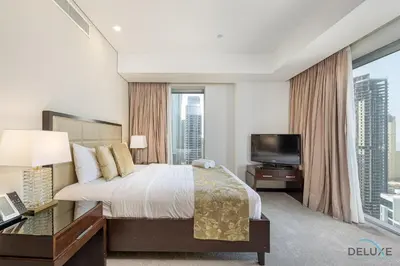 a bedroom with a large bed and a tv at Marina Canal Views 1BR Minutes Away from Marina Mall, The Address Residences, Dubai Marina by Deluxe Holiday Homes in Dubai
