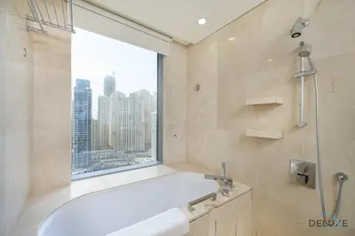 a bathroom with a bath tub and a window at Marina Canal Views 1BR Minutes Away from Marina Mall, The Address Residences, Dubai Marina by Deluxe Holiday Homes in Dubai