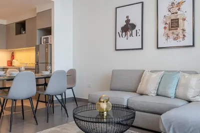 a living room with a couch and a table at Spacious 2BDR in Creek Harbor with City View in Dubai