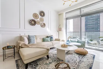 a living room with a couch and a table at GuestReady - Sea View Escape In Marina in Dubai