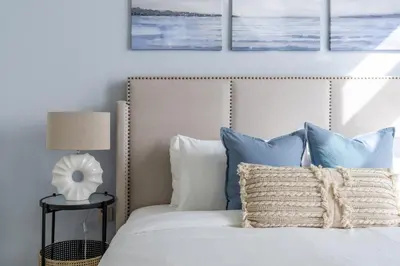a bedroom with a bed with blue and white pillows at GuestReady - Sea View Escape In Marina in Dubai