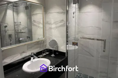 a bathroom with a sink and a glass shower at Birchfort - Newly renovated unique 1 bedroom apartment in Dubai