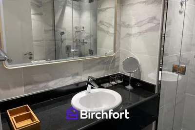 a bathroom with a sink and a mirror at Birchfort - Newly renovated unique 1 bedroom apartment in Dubai
