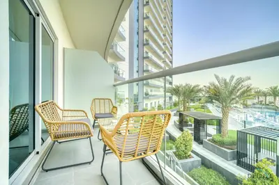 a balcony with chairs and a table on a building at Refined 1BR at Bella Rose Barsha South by Deluxe Holiday Homes in Dubai