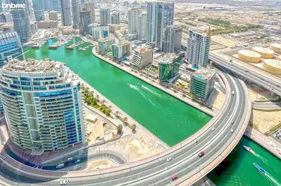 an aerial view of a city with a river and buildings at bnbme - Luxury 1BR Marina View Apt w Balcony Pool Gym Access Near JBR Beach & Walk in Dubai