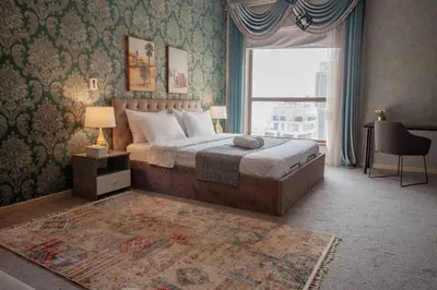 a bedroom with a large bed and a window at La Buena Vida Holiday Homes - Beach front very spacious, luxe and modern 3 bedroom with full kitchen in JBR , 3 min to the JBR beach Dubai Marina and Tram Station in Dubai