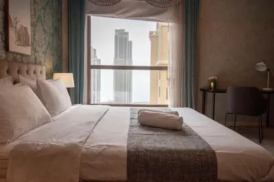 a bedroom with a large bed with a large window at La Buena Vida Holiday Homes - Beach front very spacious, luxe and modern 3 bedroom with full kitchen in JBR , 3 min to the JBR beach Dubai Marina and Tram Station in Dubai