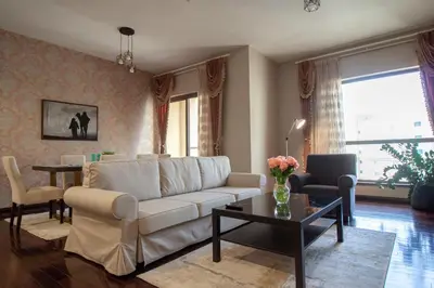 a living room with a couch and a table at La Buena Vida Holiday Homes - Beach front very spacious, luxe and modern 3 bedroom with full kitchen in JBR , 3 min to the JBR beach Dubai Marina and Tram Station in Dubai