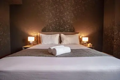 a bedroom with a large bed with two lamps at La Buena Vida Holiday Homes - Beach front very spacious, luxe and modern 3 bedroom with full kitchen in JBR , 3 min to the JBR beach Dubai Marina and Tram Station in Dubai