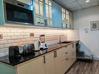 a kitchen with a sink and a counter top at La Buena Vida Holiday Homes - Modern, Luxe & Spacious 4-Bed, Full Kitchen, near to Beach, Tram & Marina in Dubai