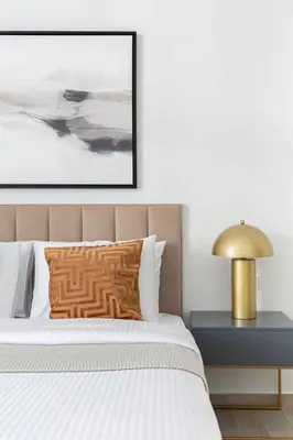 a bedroom with a bed with a pillow and a lamp at Frank Porter - Belgravia 3 in Dubai