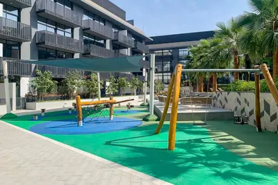 a playground in front of a building at Frank Porter - Belgravia 3 in Dubai