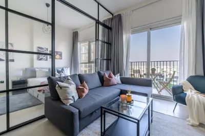 a living room with a couch and a table at GuestReady - Breath of Fresh Air in Dubai Hills in Dubai
