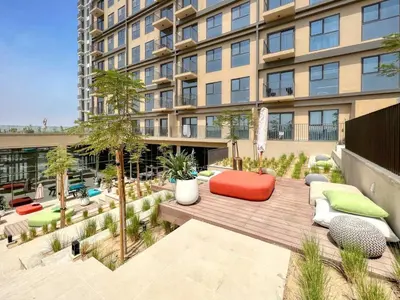 an apartment patio in front of a building at GuestReady - Breath of Fresh Air in Dubai Hills in Dubai