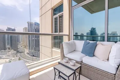 a living room with a couch and a table at GuestReady - Skyview Home with Marina View in Dubai